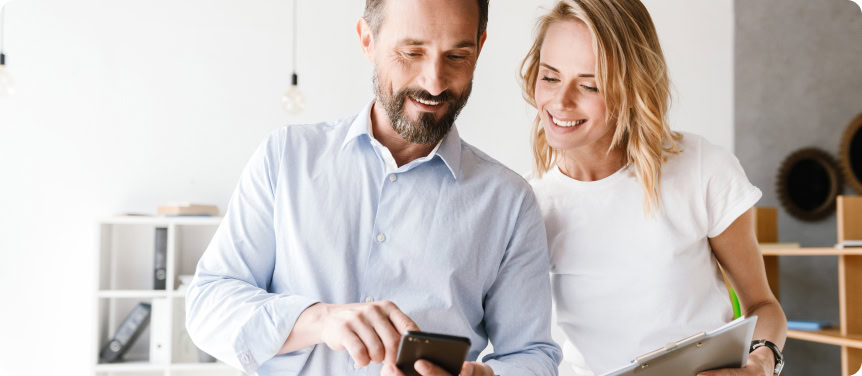 coworkers checking national seo campaign performance on mobile device
