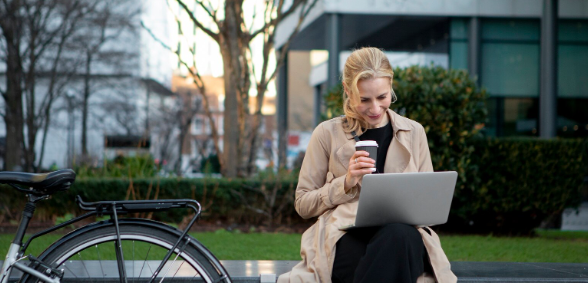 Person sitting on computer next to parking planning SEO and AEO strategy