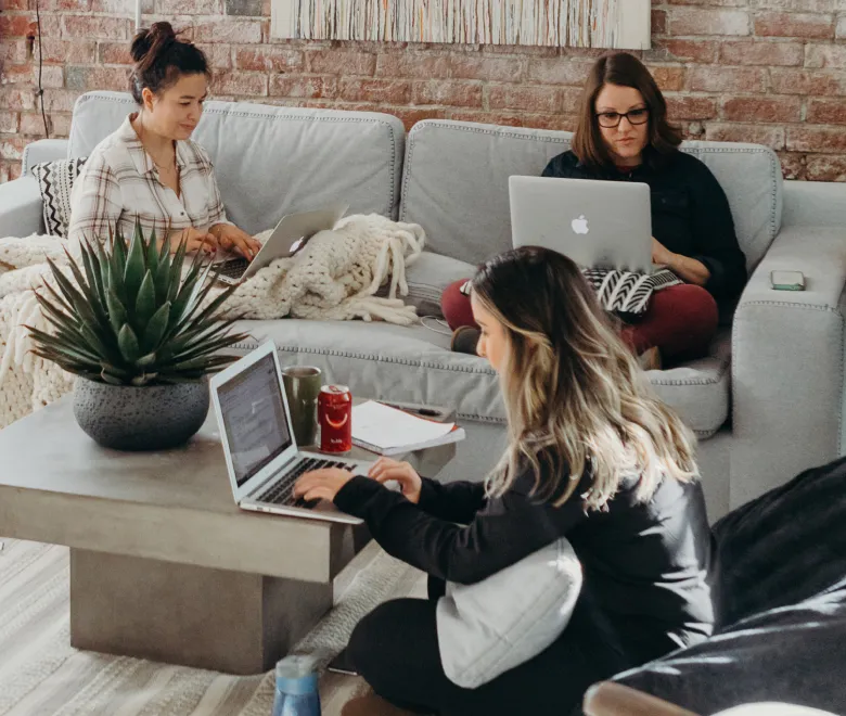 Group of women working in a livingroom